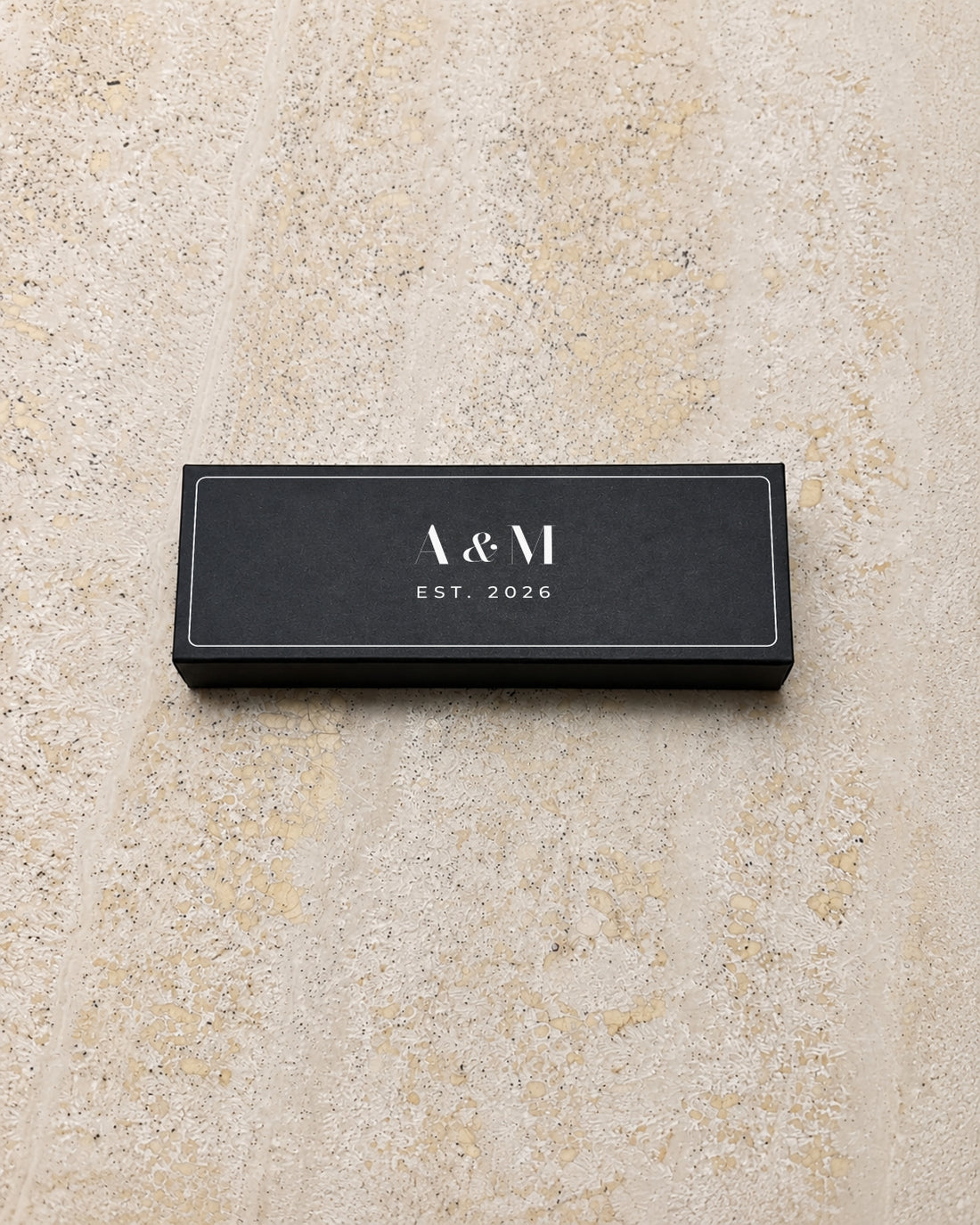 Astrid slim matchbox in black, closed on stone