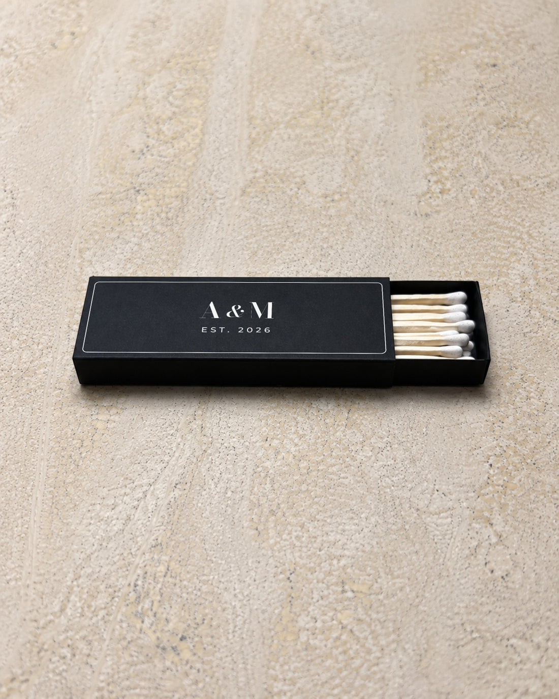 Astrid slim matchbox in black, partly open on stone