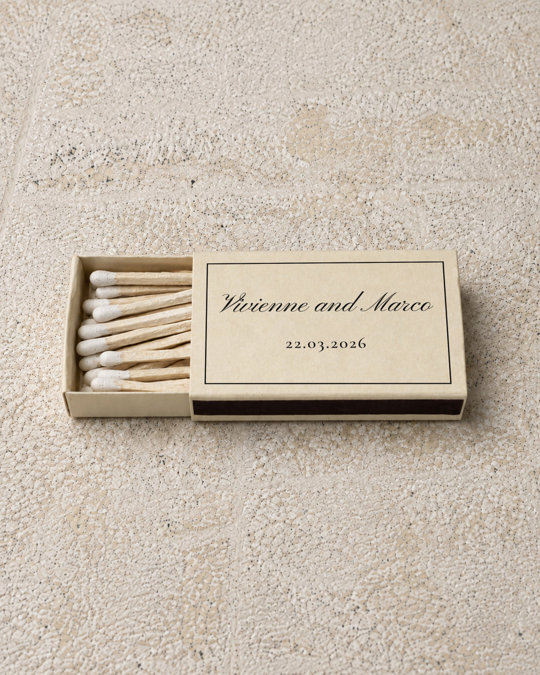 Vivienne classic matchbox in ivory, partly open on stone