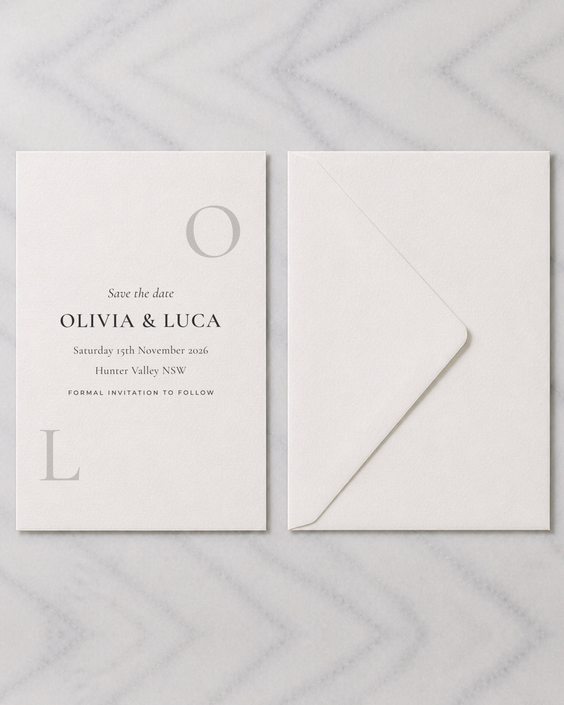 The Emblem save the date, shown with its envelope