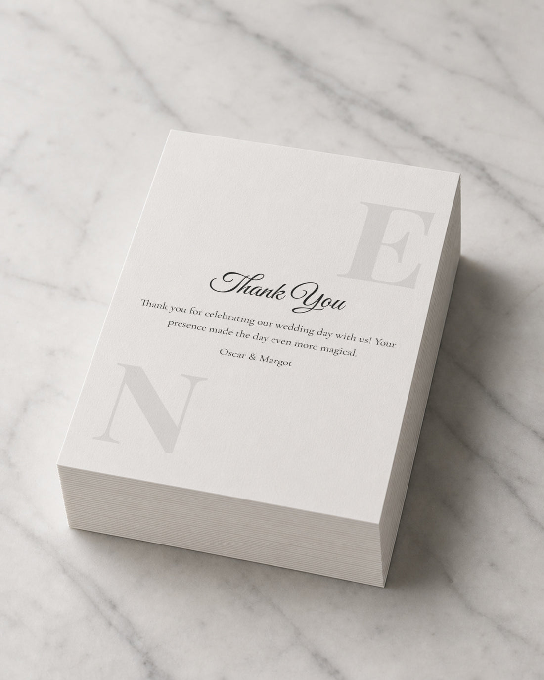 A thick stack of Monogram Script thank you cards on marble