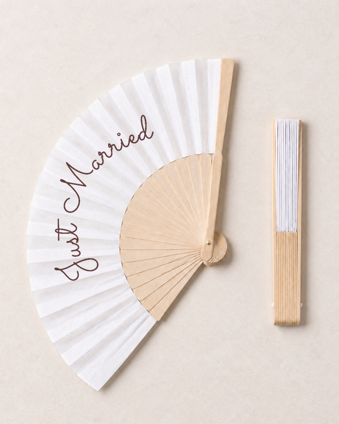 Just Married, open and closed, solid bamboo fan on light marble