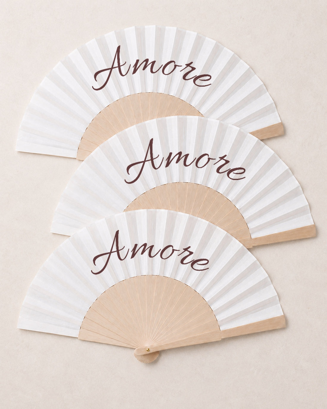 Amore, three open fans, solid bamboo fan on light marble