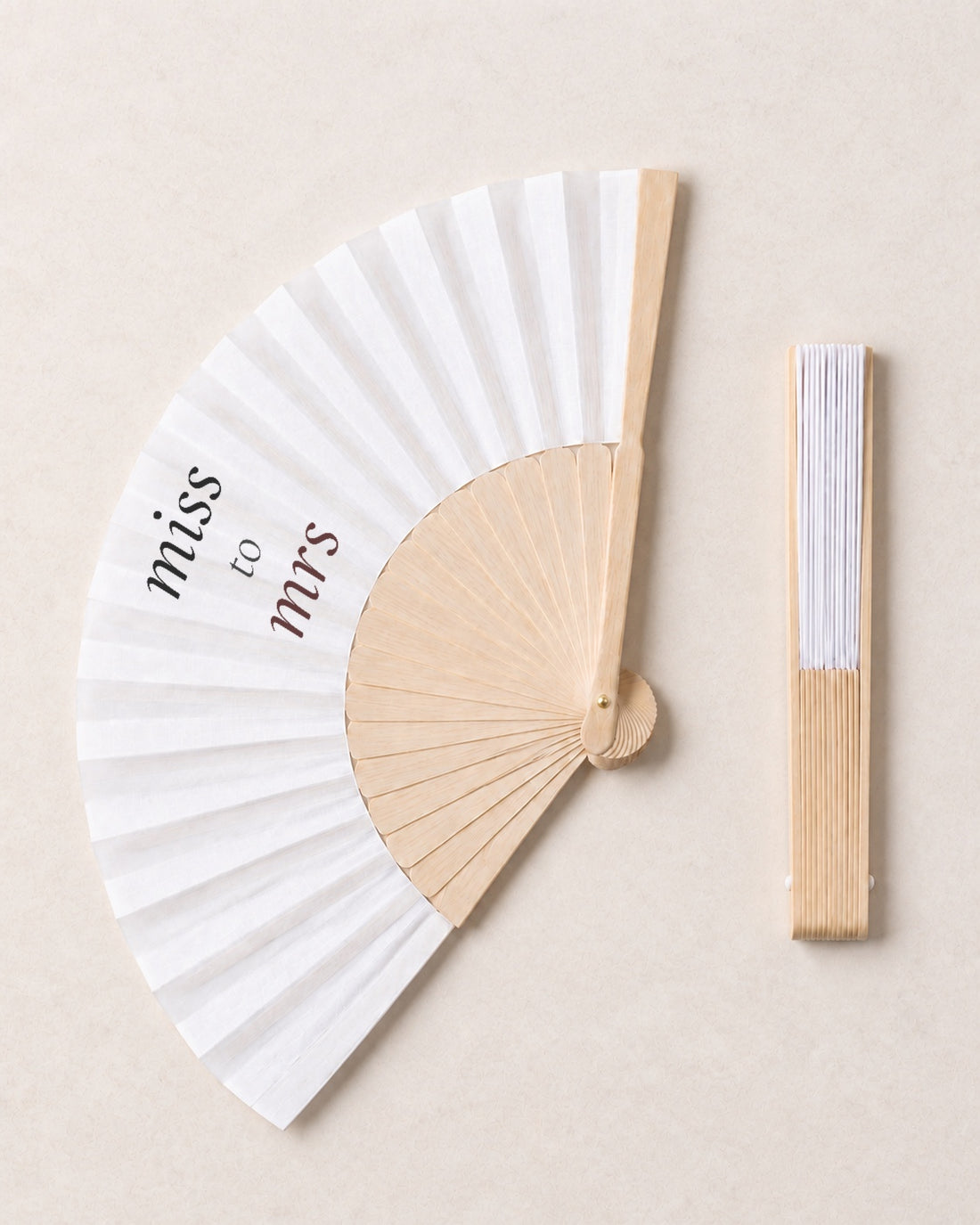 Miss to Mrs, open and closed, solid bamboo fan on light marble