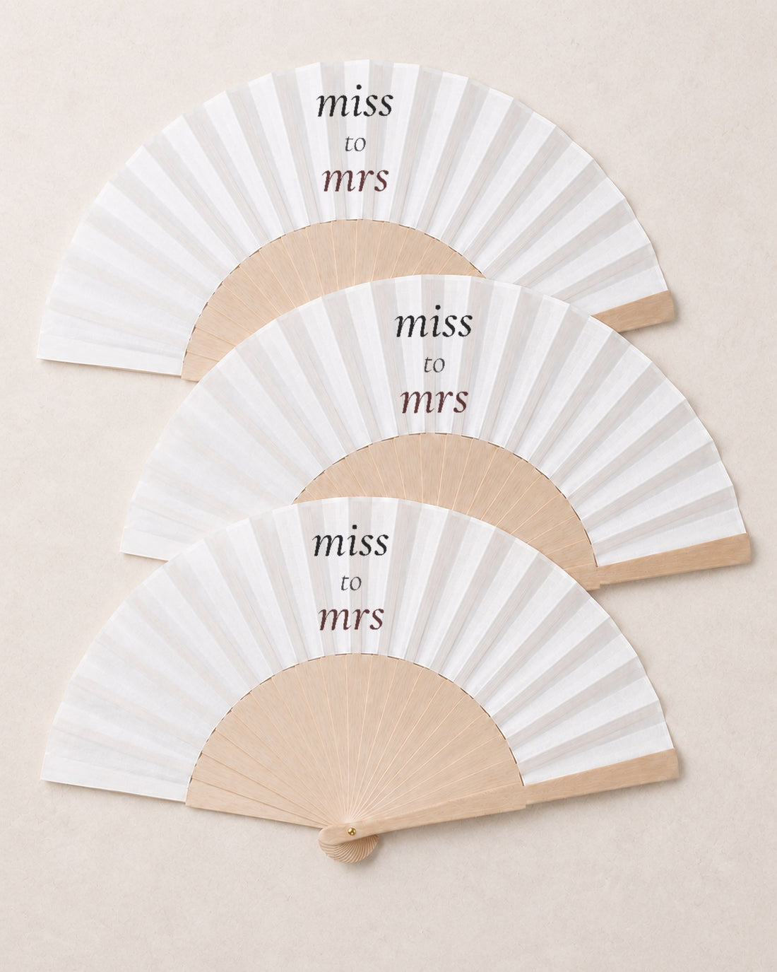 Miss to Mrs, three open fans, solid bamboo fan on light marble