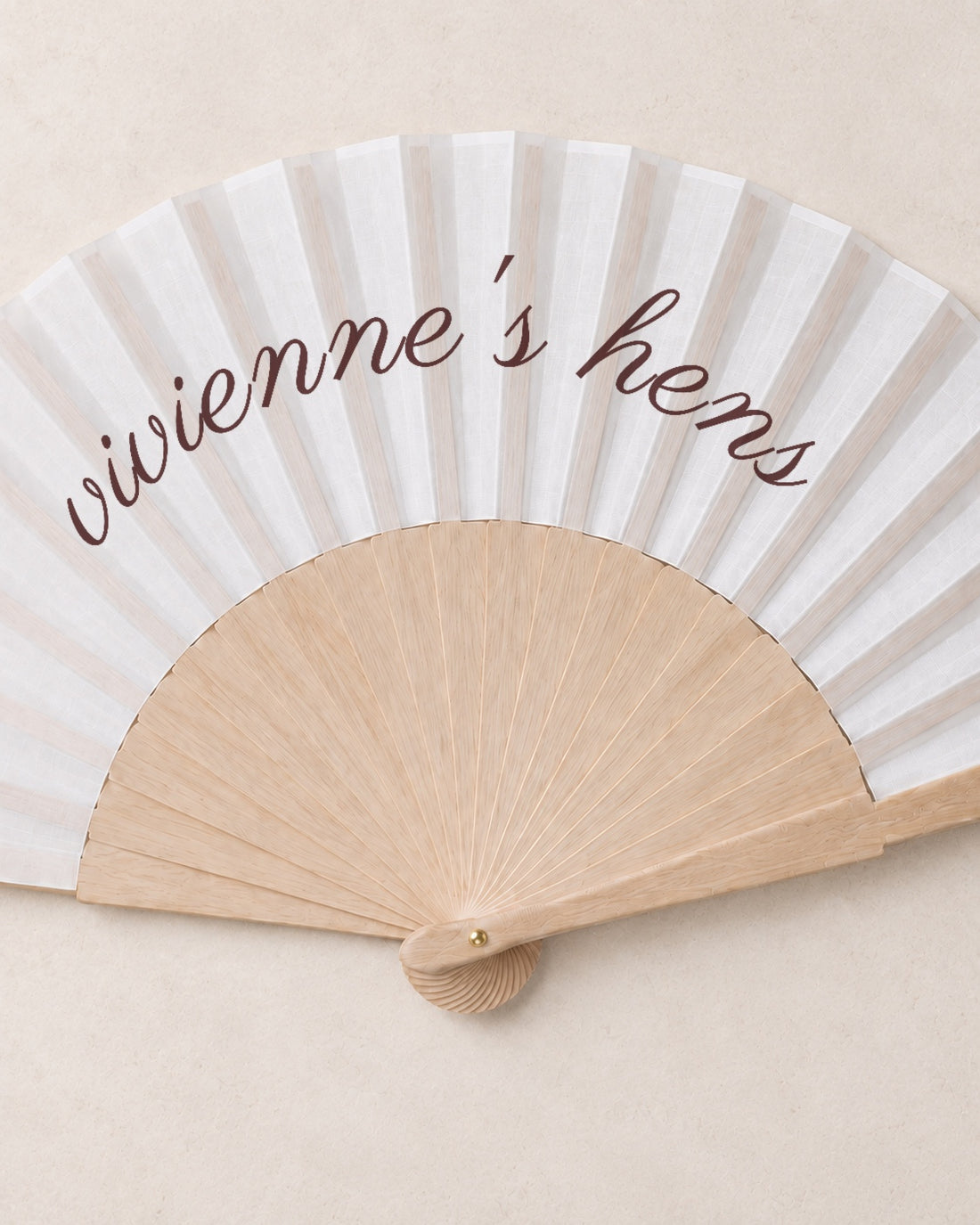 The Hen, close open fan, solid bamboo fan on light marble