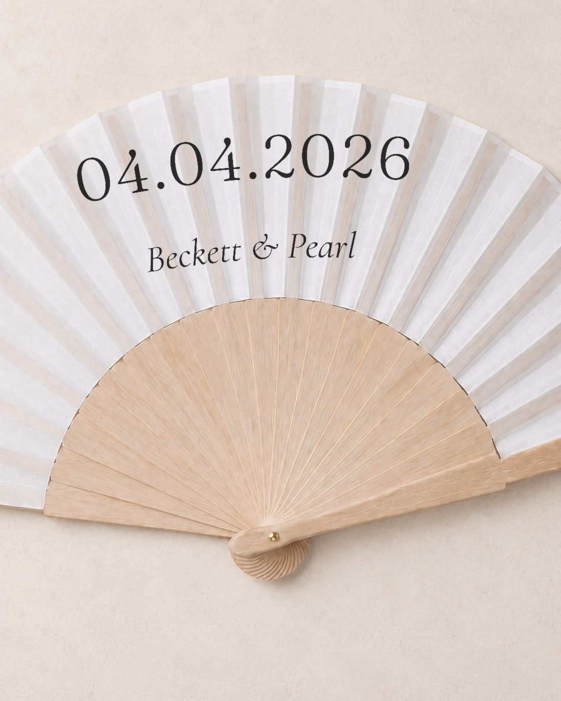 The Date, close open fan, solid bamboo fan on light marble