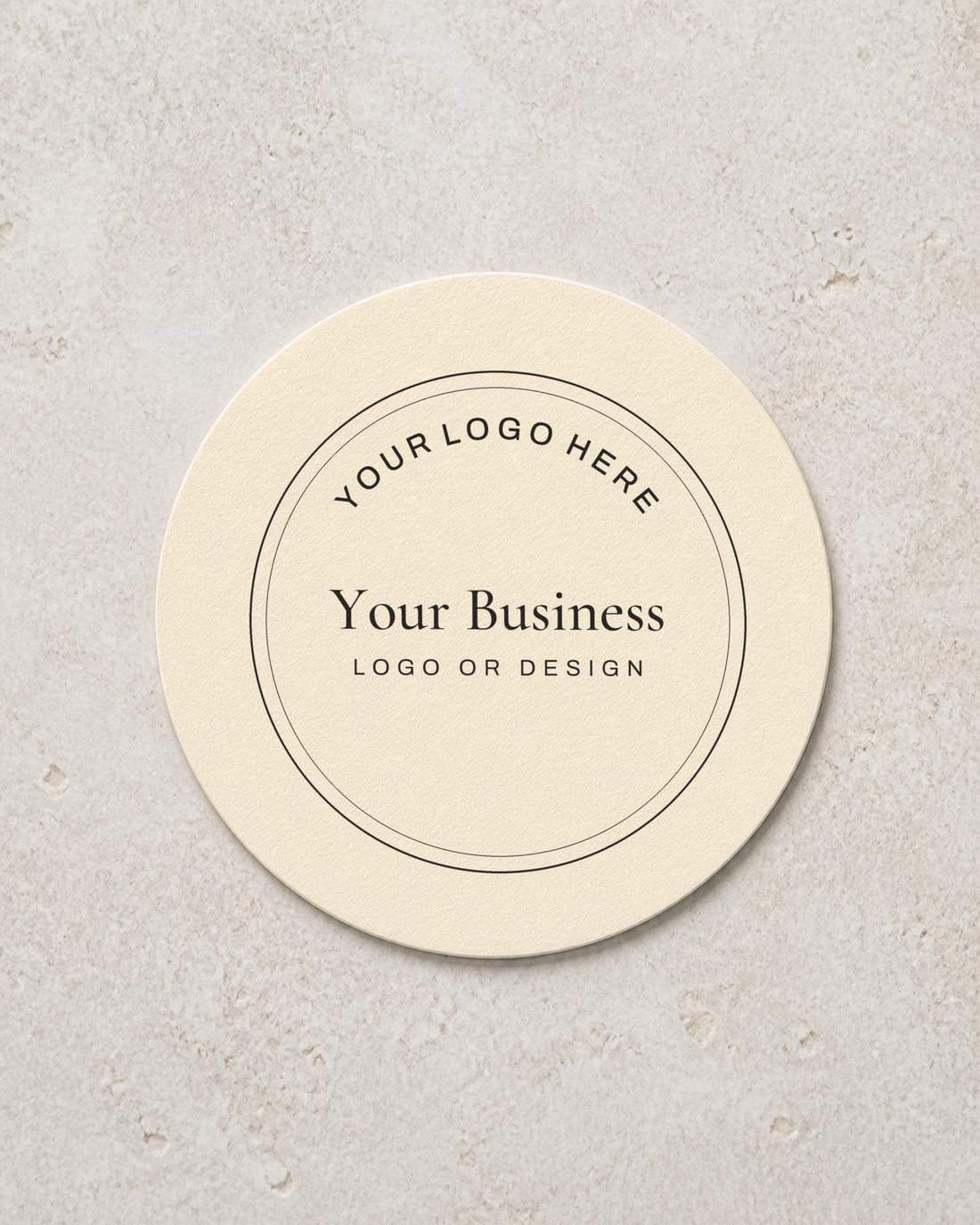 A round coaster printed with a placeholder business logo