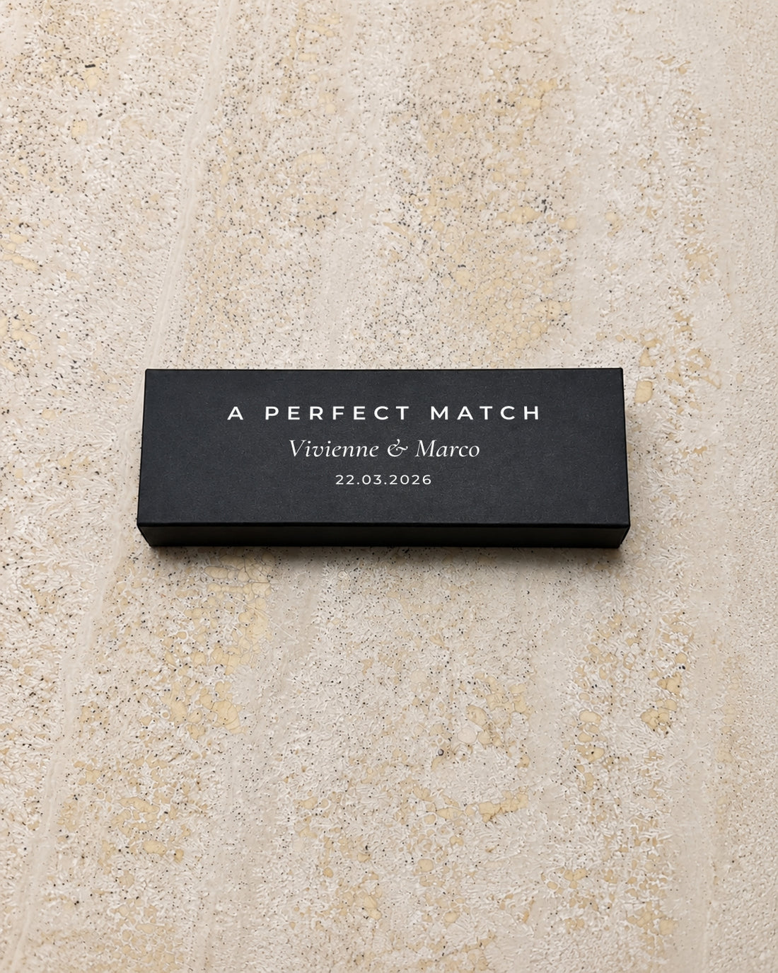 Ember slim matchbox in black, closed on stone