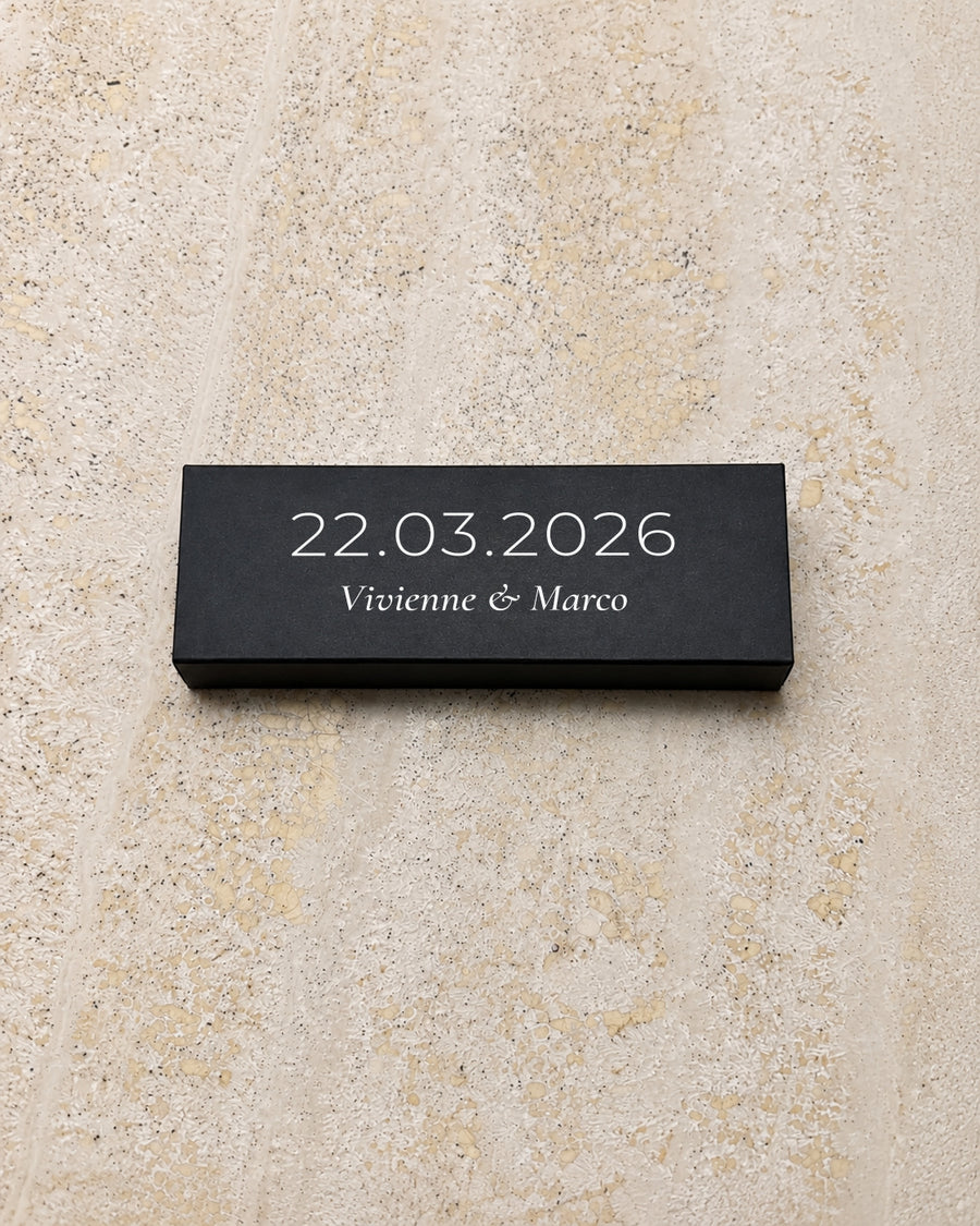 Beacon slim matchbox in black, closed on stone
