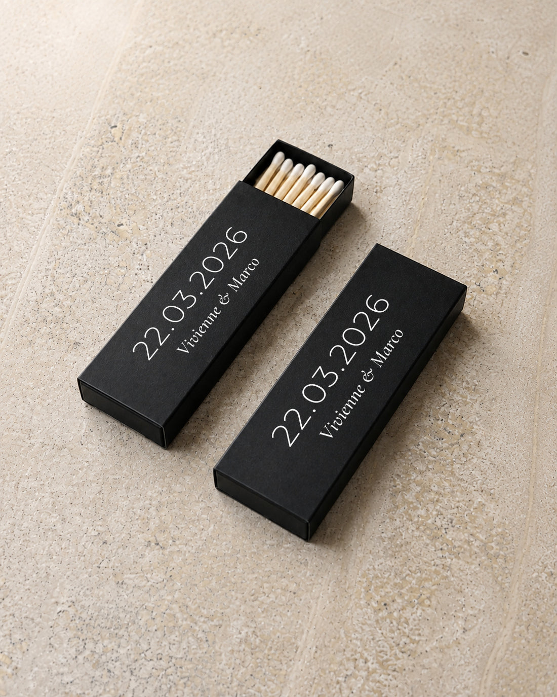 Beacon slim matchbox in black, angled open and closed pair on stone