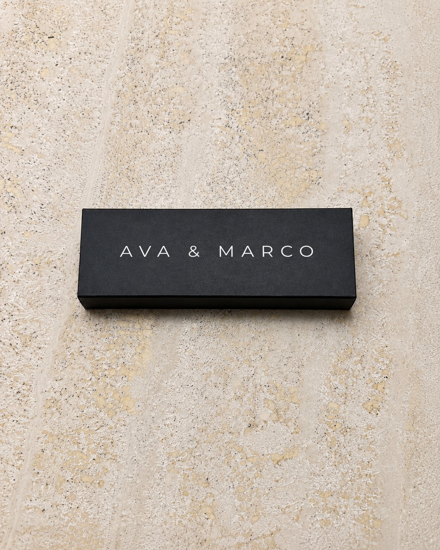 Alba slim matchbox in black, closed on stone