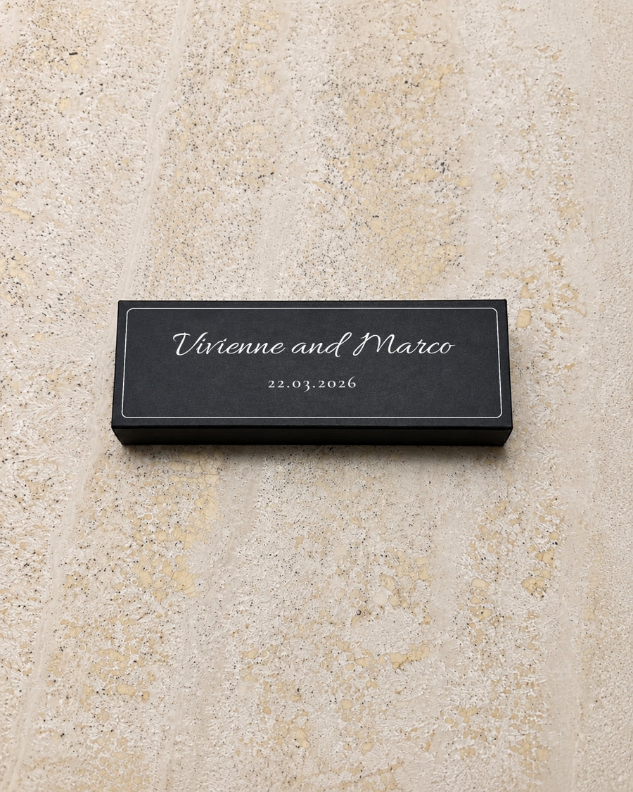 Flint slim matchbox in black, closed on stone