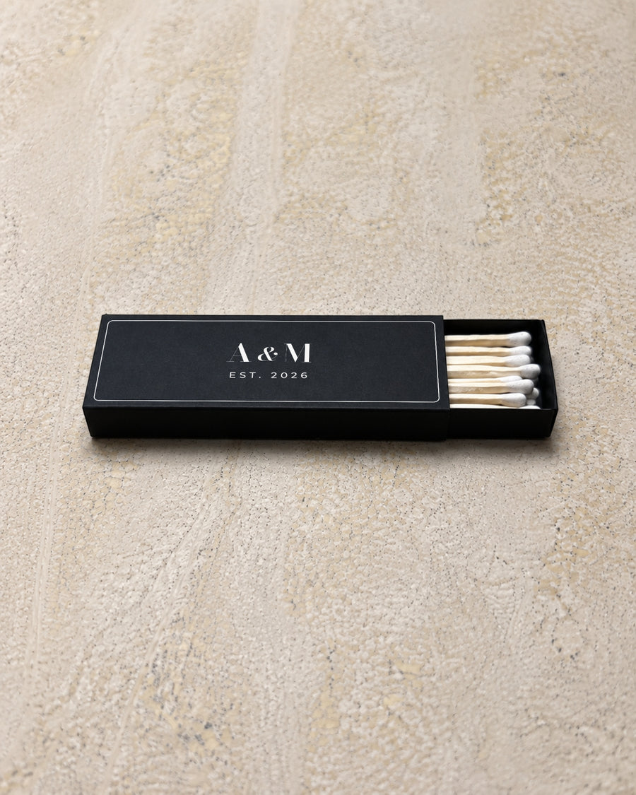 Astrid slim matchbox in black, partly open on stone