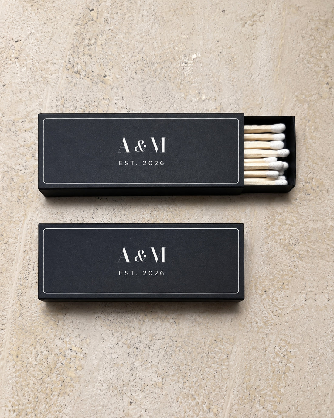 Astrid slim matchbox in black, open and closed pair on stone