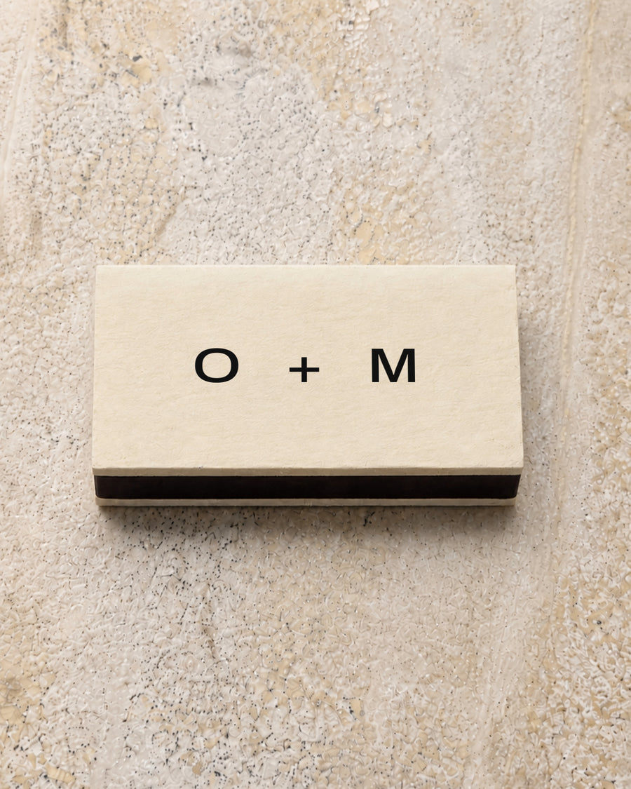 Emblem classic matchbox in ivory, closed on stone