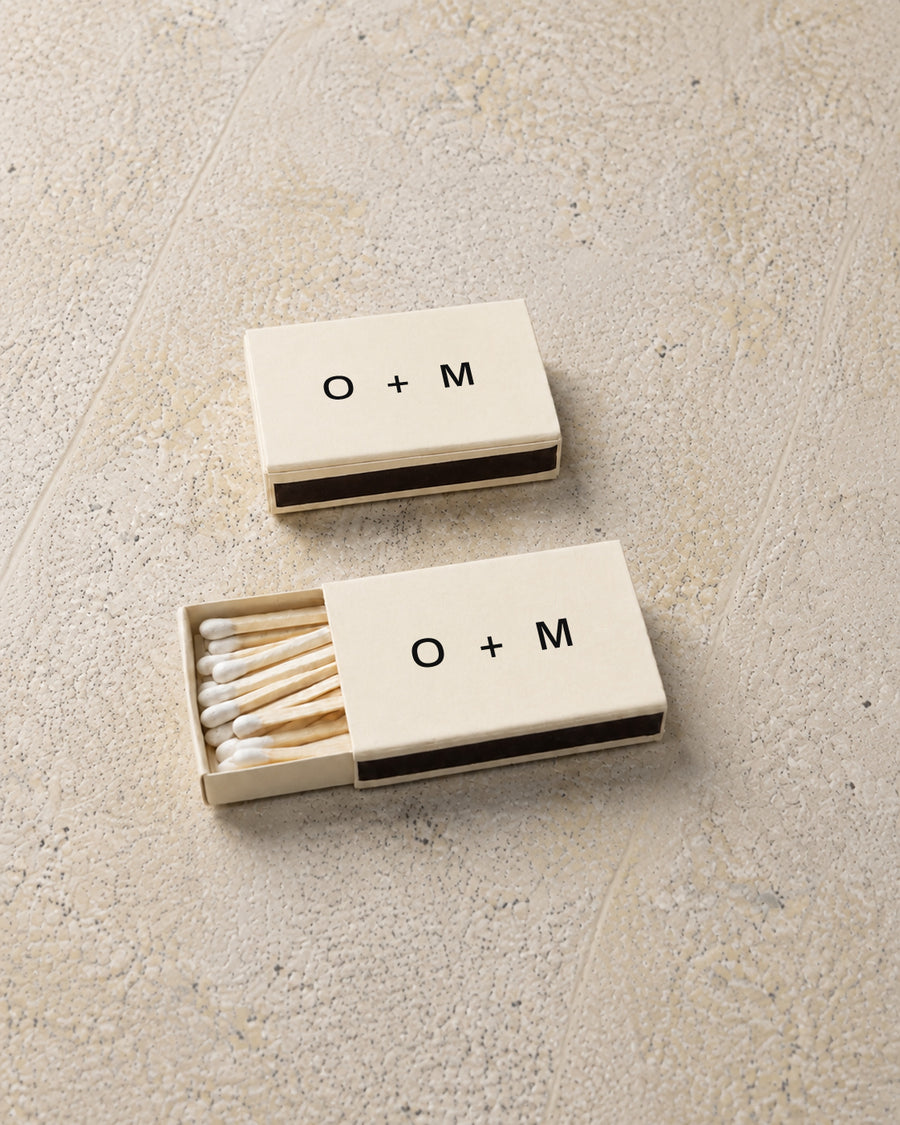 Emblem classic matchbox in ivory, angled open and closed pair on stone