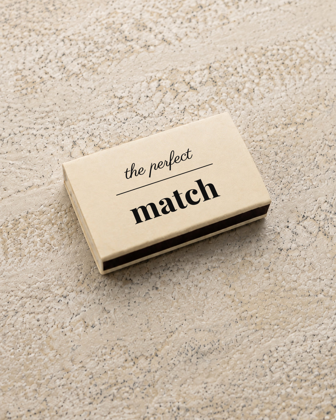 Marlowe classic matchbox in ivory, closed at an angle on stone