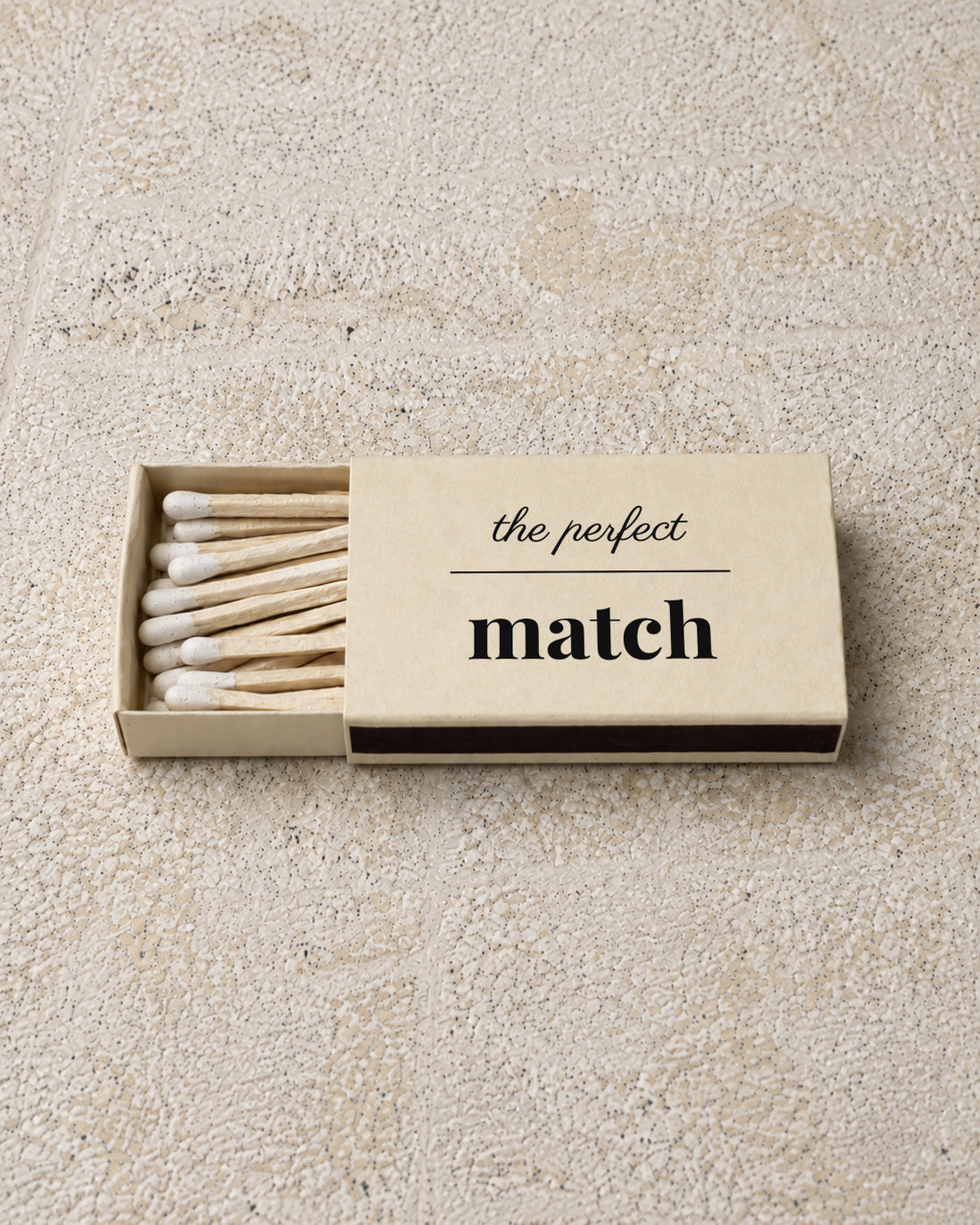 Marlowe classic matchbox in ivory, partly open on stone