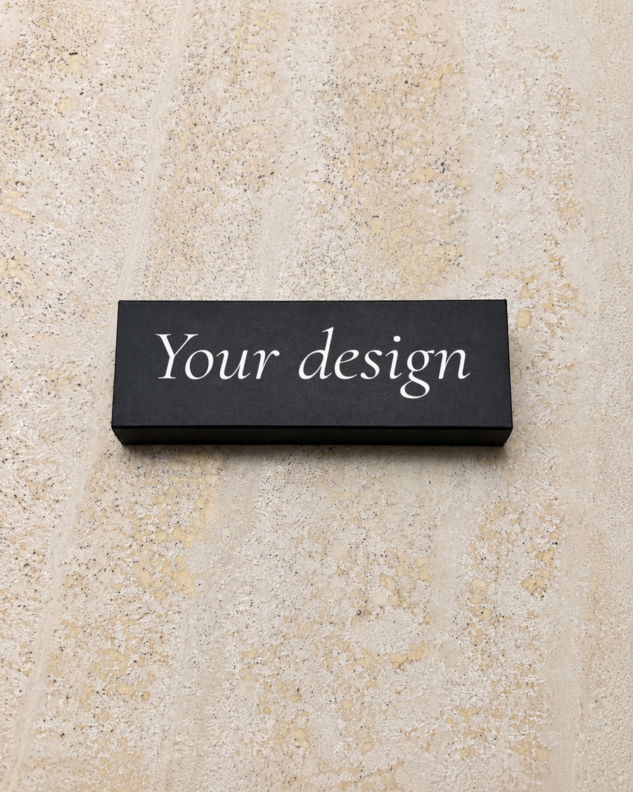 Your Design slim matchbox in black, closed on stone