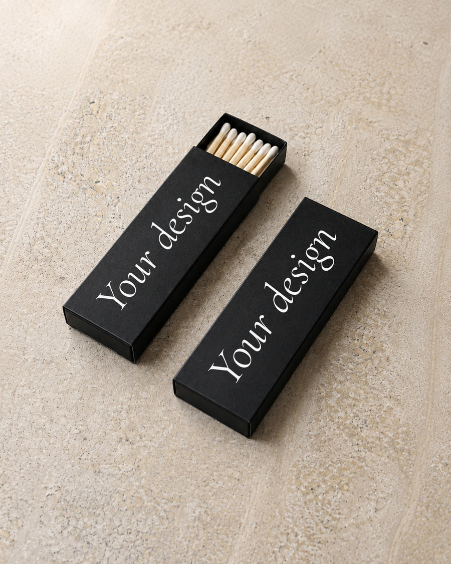 Your Design slim matchbox in black, angled open and closed pair on stone