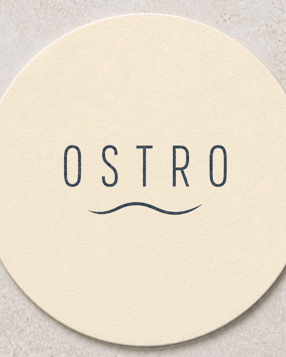 Close view of the printed mark on an ivory branded coaster