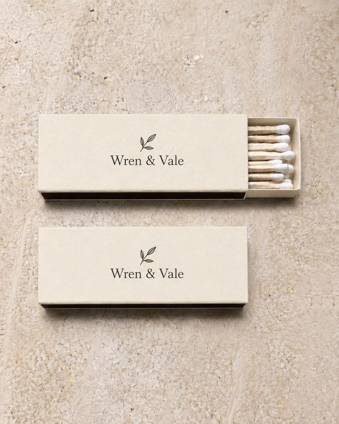 Two ivory slim matchboxes printed with a winery mark in black, an example brand