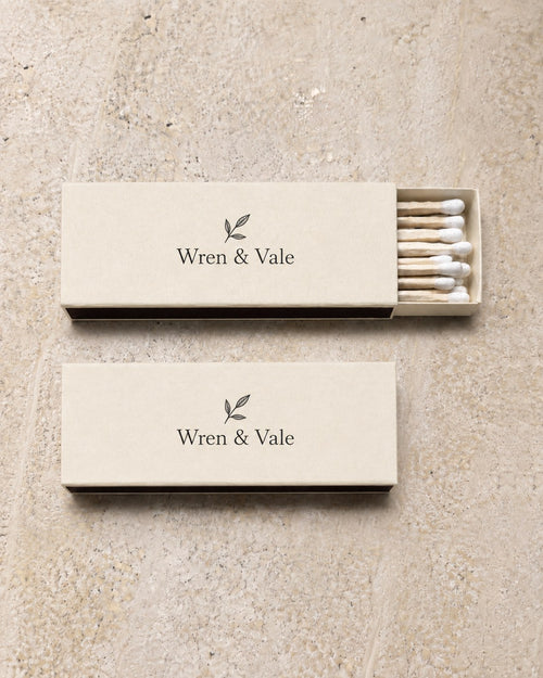 Two ivory slim matchboxes printed with a winery mark in black, an example brand
