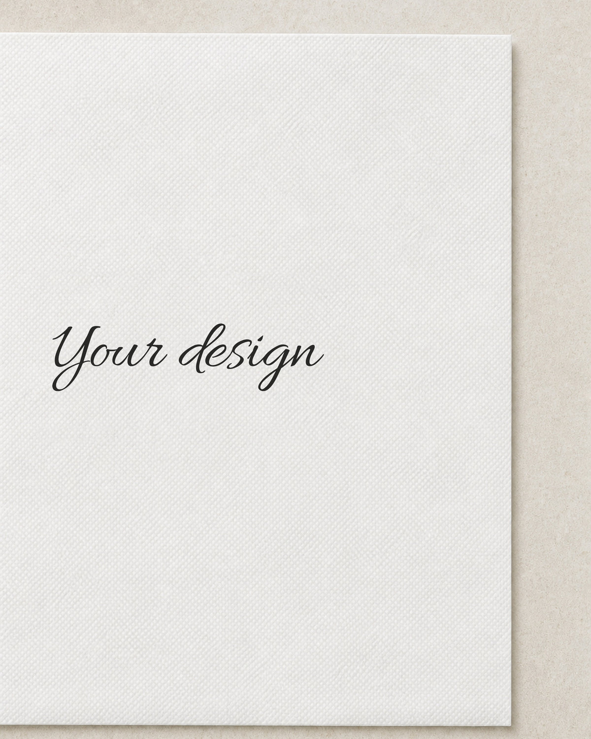 A blank cocktail napkin printed with the words Your design, close detail