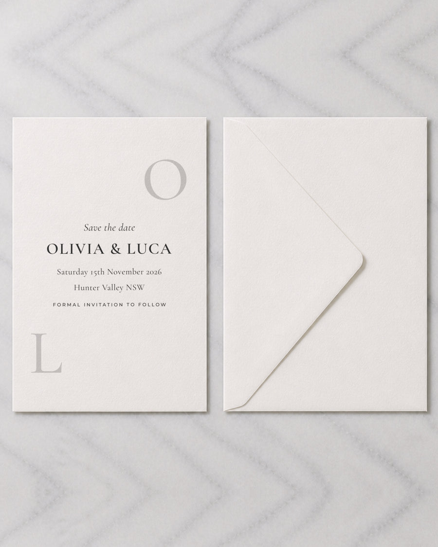 The Emblem save the date, shown with its envelope