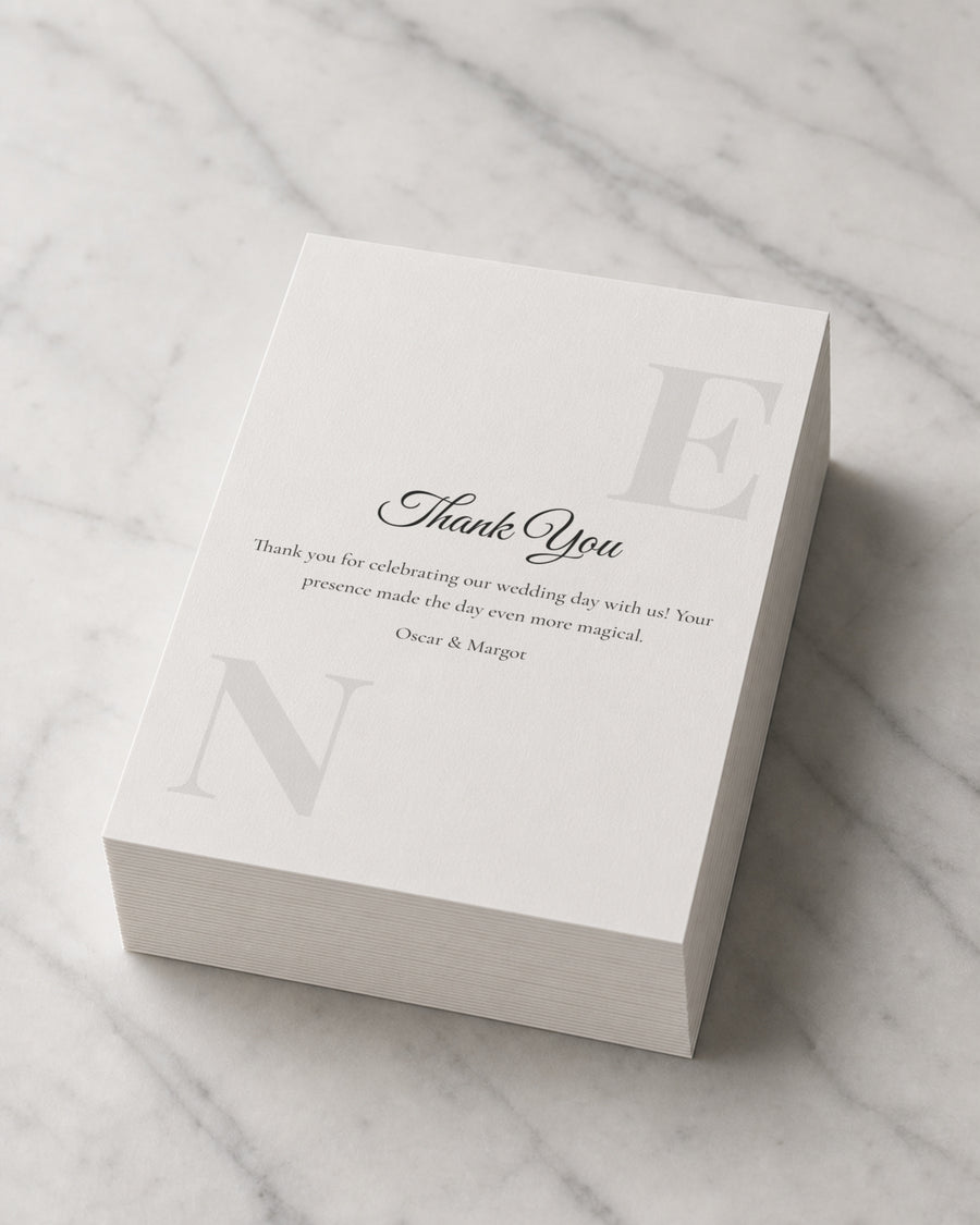 A thick stack of Monogram Script thank you cards on marble