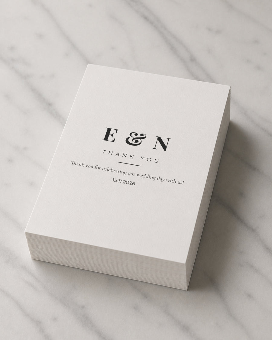 A thick stack of Initials thank you cards on marble