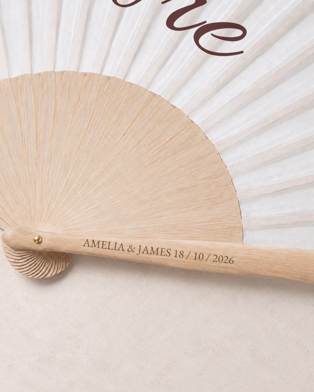 Amore, engraving detail, solid bamboo fan on light marble