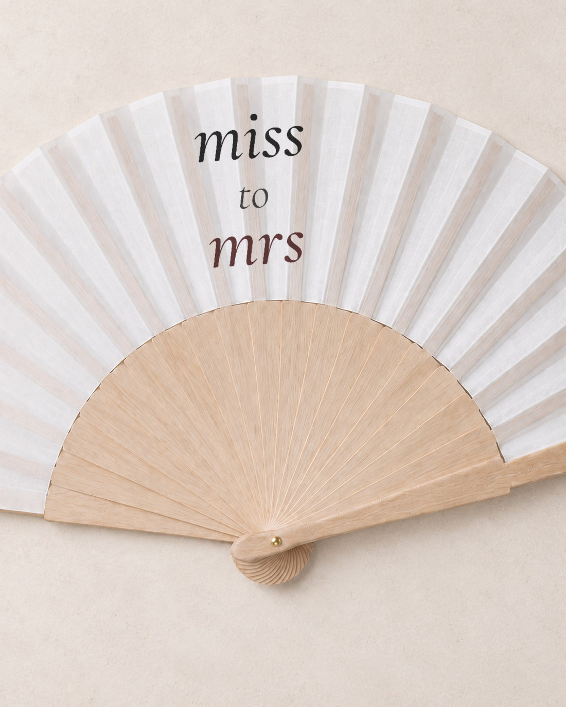 Miss to Mrs, close open fan, solid bamboo fan on light marble