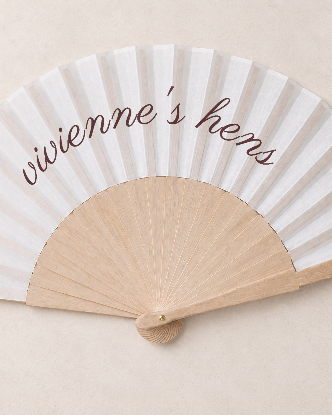 The Hen, close open fan, solid bamboo fan on light marble