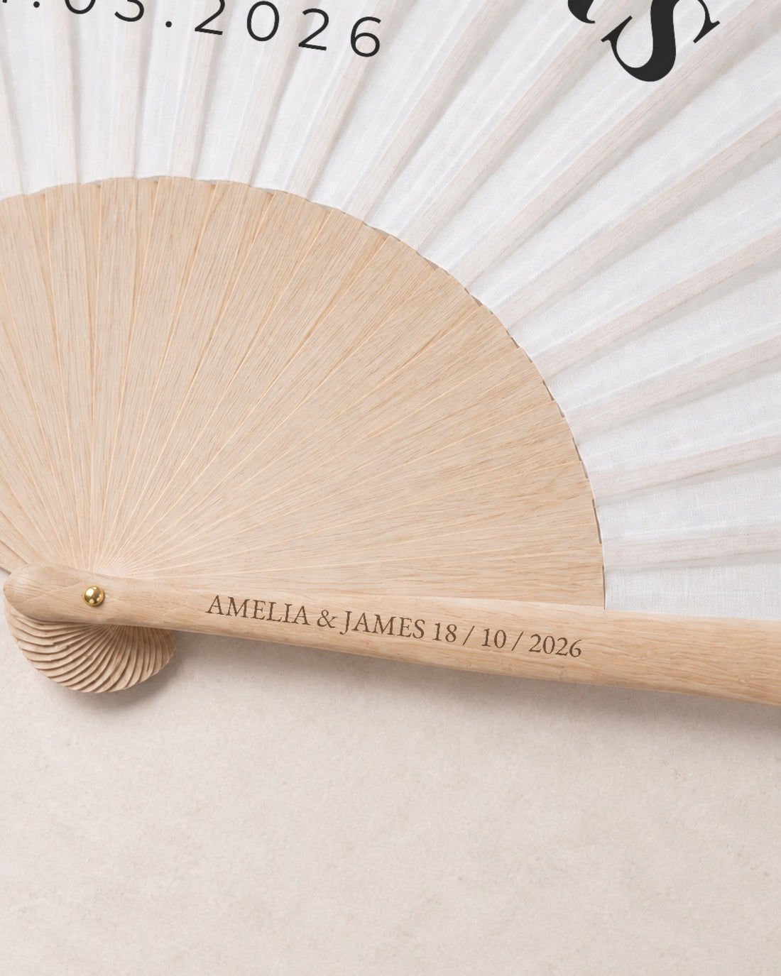 The Name, engraving detail, solid bamboo fan on light marble