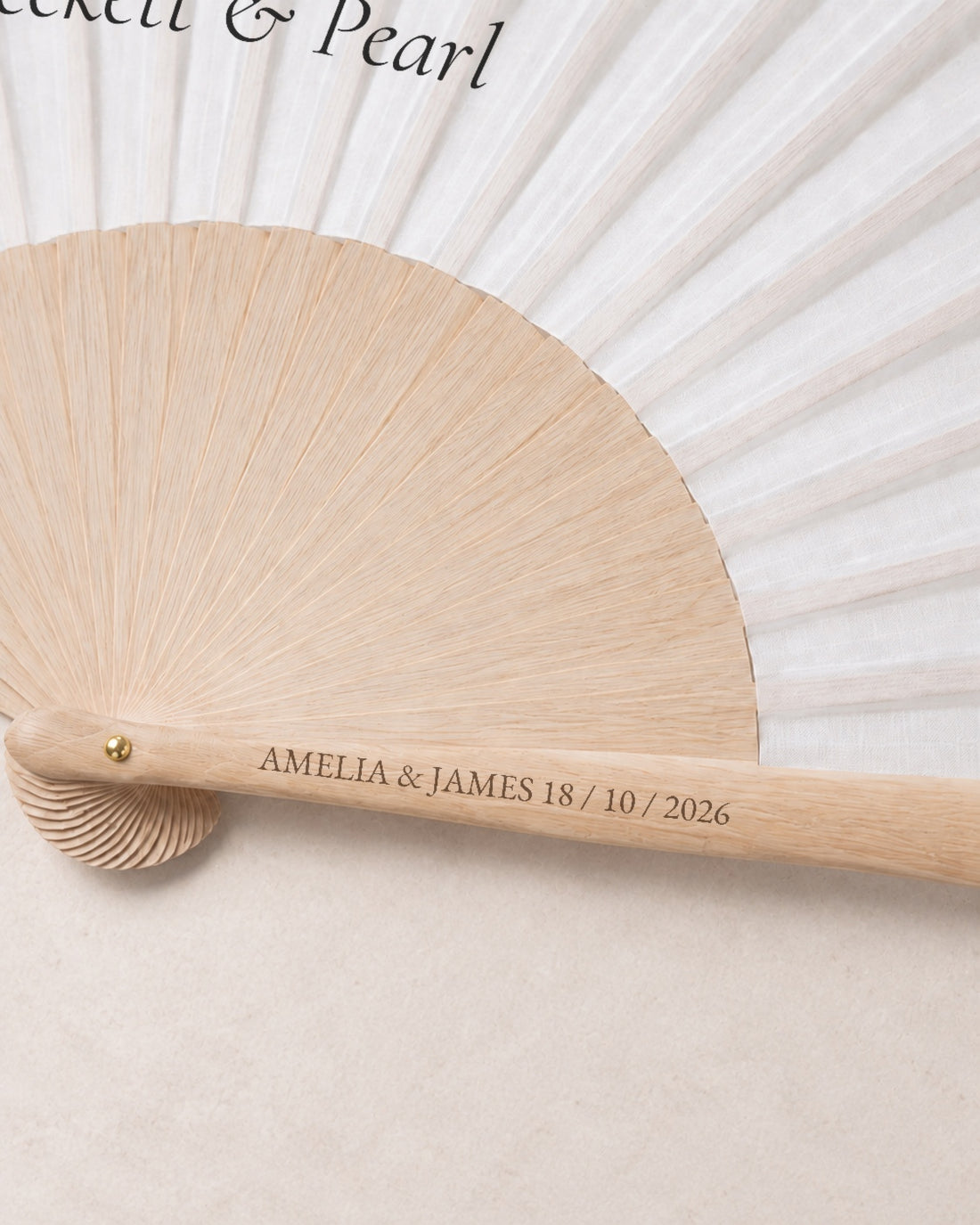 The Date, engraving detail, solid bamboo fan on light marble