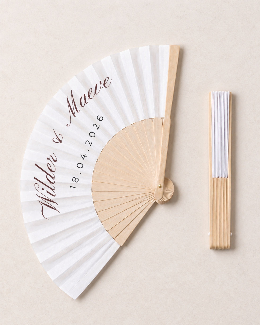 Wilder, open and closed, solid bamboo fan on light marble