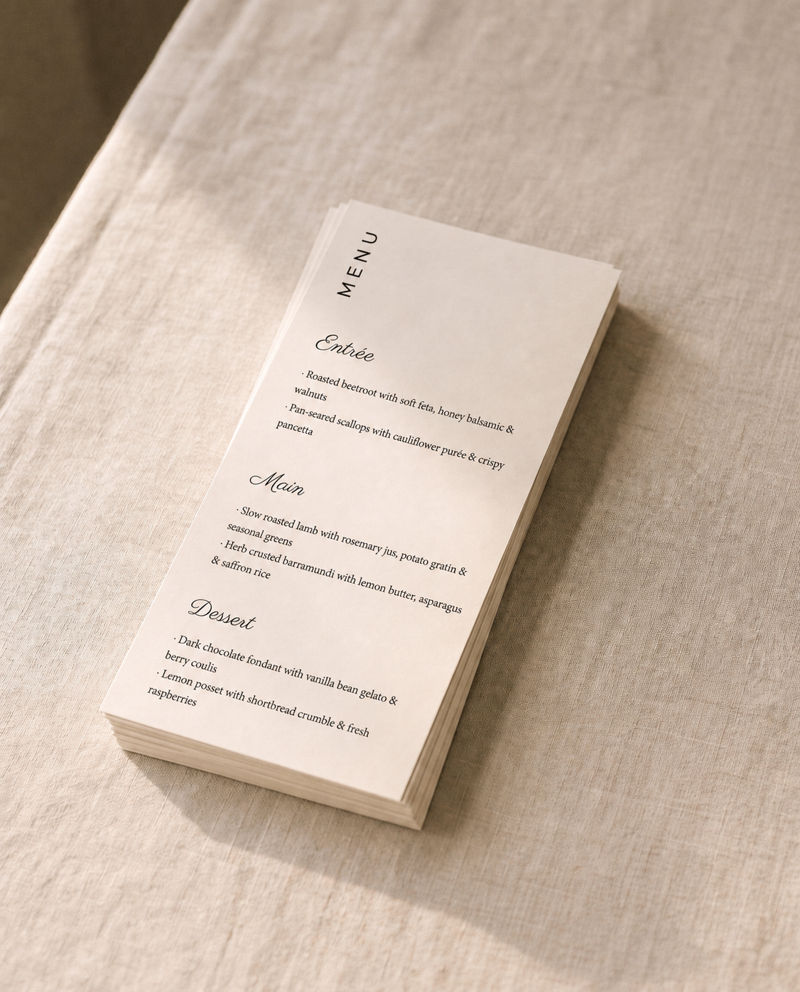 Stack of printed Solène menus on natural linen
