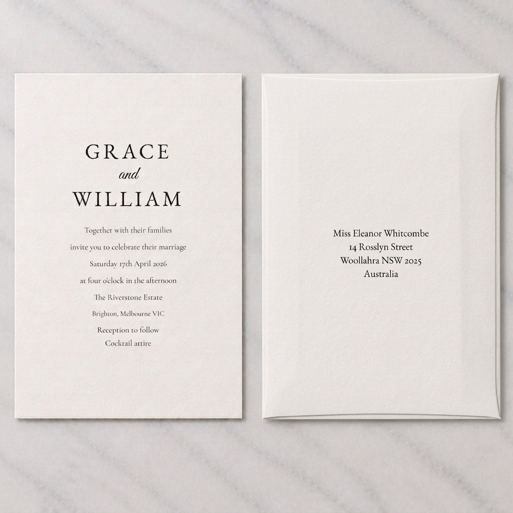 An invitation beside its white envelope, printed with a guest name and postal address
